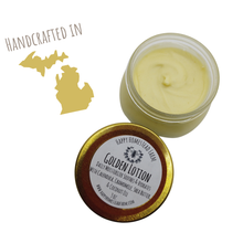 Load image into Gallery viewer, Open 3 oz jar of Golden Lotion beside its gold lid, with a Handcrafted in Michigan graphic.